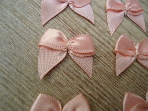 Salmon Pink satin ribbon bows, 15 in a pack, dressmaking supplies and online haberdashery, pretty ribbon bows for sale, trimmings and accesories for sewing online shop at HandBound Costume Supplies