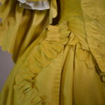 1760s fashion - yellow sack back gown with furbelow trim