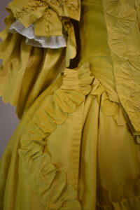 1760s fashion - yellow sack back gown with furbelow trim